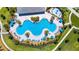 Aerial view of the community pool with palm trees, seating, and splash pad at 9909 Alliteration Aly, Winter Garden, FL 34787