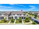 Exterior shot of townhome with manicured lawn, front porch and driveway at 9909 Alliteration Aly, Winter Garden, FL 34787