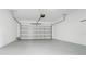 Spacious garage with a white door and ample space at 9909 Alliteration Aly, Winter Garden, FL 34787