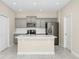 Modern kitchen featuring gray cabinets, stainless steel appliances, and a center island with bar seating at 9909 Alliteration Aly, Winter Garden, FL 34787