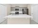 Modern kitchen featuring gray cabinetry, stainless steel appliances, and a spacious white countertop island at 9909 Alliteration Aly, Winter Garden, FL 34787