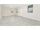 Bright, empty living room featuring neutral paint, recessed lighting, and tile flooring at 9909 Alliteration Aly, Winter Garden, FL 34787