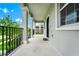 Inviting covered porch featuring stately columns and black railings, perfect for outdoor relaxation at 9909 Alliteration Aly, Winter Garden, FL 34787
