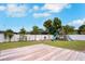Spacious backyard with a wooden deck, a playground, and a well-maintained lawn, perfect for outdoor activities at 1167 Lake Blanche Dr, Orlando, FL 32808