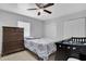 Bedroom with ceiling fan, dresser, patterned bedding, and two closets at 1167 Lake Blanche Dr, Orlando, FL 32808