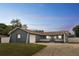 Charming single-story home featuring an attached garage, basketball hoop, and well-manicured lawn at 1167 Lake Blanche Dr, Orlando, FL 32808