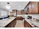 Modern kitchen featuring granite counters, stainless steel appliances, and dark wood cabinetry at 1167 Lake Blanche Dr, Orlando, FL 32808