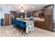 Open kitchen with island and breakfast bar seating, stainless steel appliances, and wood floors at 1167 Lake Blanche Dr, Orlando, FL 32808