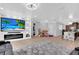 Open-concept living room with entertainment center, electric fireplace, adjacent to kitchen with granite countertops at 1167 Lake Blanche Dr, Orlando, FL 32808