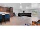 View of the living room featuring a large leather sofa and open access to the kitchen at 1167 Lake Blanche Dr, Orlando, FL 32808