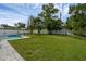 Large backyard with lush lawn, mature trees, and a pool, offering ample space for outdoor activities at 1328 Vassar St, Orlando, FL 32804