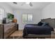 Comfortable bedroom with a modern bed, wood dresser, and a large window overlooking the yard, creating a serene retreat at 1328 Vassar St, Orlando, FL 32804