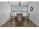 Well-lit dining room with hardwood floors, a modern chandelier, and shuttered windows offering a pleasant view at 1328 Vassar St, Orlando, FL 32804