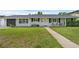 Charming home with well-manicured lawn, flower beds, modern front door, and attached garage at 1328 Vassar St, Orlando, FL 32804