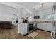 Efficient kitchen with white cabinetry, stainless steel appliances, and hardwood flooring, with a view to the living room at 1328 Vassar St, Orlando, FL 32804