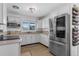Updated kitchen featuring white cabinets, stainless steel appliances, and a functional layout, with a view to the front window at 1328 Vassar St, Orlando, FL 32804