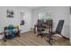 Home office with dual monitors, fitness equipment, closet, and wood floors, perfect for work and workouts at 1328 Vassar St, Orlando, FL 32804