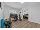 Versatile office space with wood floors, desk setup, and fitness equipment, connected to an adjacent bedroom at 1328 Vassar St, Orlando, FL 32804
