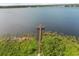 Stunning aerial view of dock and expansive lake, surrounded by lush greenery at 14016 Fox Glove St, Winter Garden, FL 34787