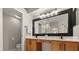 Bathroom vanity with double sinks, a large framed mirror, updated fixtures, and white towels at 14016 Fox Glove St, Winter Garden, FL 34787