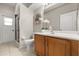 Bright bathroom featuring tile floors, a wooden vanity, and a glass-enclosed shower at 14016 Fox Glove St, Winter Garden, FL 34787