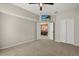 Neutral bedroom with carpet, neutral walls, ceiling fan, a TV, and a view into the dining room at 14016 Fox Glove St, Winter Garden, FL 34787