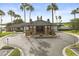 Beautiful clubhouse entrance with palm trees, well-maintained landscaping, and circular driveway at 14016 Fox Glove St, Winter Garden, FL 34787