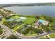 Aerial view of community amenities including pool, tennis courts, and scenic lake at 14016 Fox Glove St, Winter Garden, FL 34787