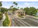 Community entrance with security gate, well-maintained landscaping, and palm-lined street at 14016 Fox Glove St, Winter Garden, FL 34787
