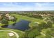Scenic aerial view of golf course with lush green fairways and a tranquil lake at 14016 Fox Glove St, Winter Garden, FL 34787