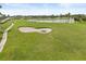 Scenic golf course view with lush green fairways and a pristine sand bunker at 14016 Fox Glove St, Winter Garden, FL 34787
