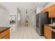 Bright kitchen featuring tile flooring, stainless appliances, and a dining nook with a view of the living room at 14016 Fox Glove St, Winter Garden, FL 34787