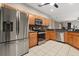 Well-lit kitchen featuring stainless steel appliances, warm wood cabinets, and neutral countertops at 14016 Fox Glove St, Winter Garden, FL 34787