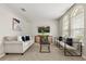 Bright living room featuring large windows, neutral walls, and comfortable seating arrangement at 14016 Fox Glove St, Winter Garden, FL 34787
