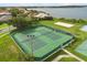 Aerial view of well-maintained community tennis courts with lake view at 14016 Fox Glove St, Winter Garden, FL 34787