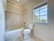 Bathroom features a tiled shower/tub and a window at 14044 Chicora Crossing Blvd, Orlando, FL 32828