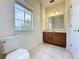 Bright bathroom features a vanity with wood cabinets at 14044 Chicora Crossing Blvd, Orlando, FL 32828