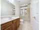 Well-lit bathroom features a glass enclosed shower and vanity with wood cabinets at 14044 Chicora Crossing Blvd, Orlando, FL 32828