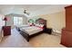 Spacious bedroom featuring two beds, a ceiling fan, and a large window allowing ample natural light at 14044 Chicora Crossing Blvd, Orlando, FL 32828