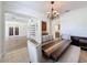 Cozy dining room with stylish chandelier, a rustic wooden table, and a view of the front entrance at 14044 Chicora Crossing Blvd, Orlando, FL 32828