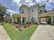 Charming two-story home with a well-manicured front yard, portico, and a side-entry garage at 14044 Chicora Crossing Blvd, Orlando, FL 32828