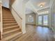 Inviting foyer features hardwood floors, a staircase, and an arched entryway into the living room at 14044 Chicora Crossing Blvd, Orlando, FL 32828