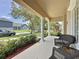 Inviting covered front porch featuring comfortable seating, providing a relaxing outdoor space at 14044 Chicora Crossing Blvd, Orlando, FL 32828