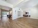 Spacious living room with hardwood floors seamlessly connects to the dining area and staircase at 14044 Chicora Crossing Blvd, Orlando, FL 32828