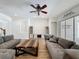 Comfortable living room featuring hardwood floors, a ceiling fan, and two sofas for ample seating at 14044 Chicora Crossing Blvd, Orlando, FL 32828