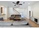 Inviting living room featuring hardwood floors, a ceiling fan, and two sofas providing ample seating at 14044 Chicora Crossing Blvd, Orlando, FL 32828