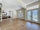 Bright and airy living room with hardwood floors, arched entryways, and decorative front door with glass insets at 14044 Chicora Crossing Blvd, Orlando, FL 32828