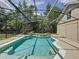 Enclosed in-ground pool with adjacent spa and screened enclosure at 14044 Chicora Crossing Blvd, Orlando, FL 32828