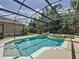 Beautiful screened-in pool and spa surrounded by mature landscaping at 14044 Chicora Crossing Blvd, Orlando, FL 32828