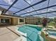 Relaxing screened pool area with a hot tub and beautiful plants, perfect for outdoor entertaining at 14044 Chicora Crossing Blvd, Orlando, FL 32828